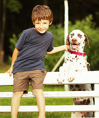 Image showing little cute boy with dalmatian dog