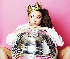 Image showing young cute disco girl on pink background with disco ball and cro