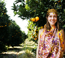 Image showing pretty islam woman in orange grove smiling, real muslim girl