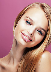 Image showing young pretty blonde woman with hairstyle close up and makeup on pink background