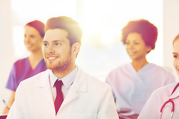 Image showing happy doctor over group of medics at hospital