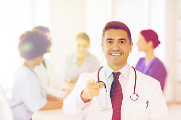 Image showing happy doctor over group of medics at hospital