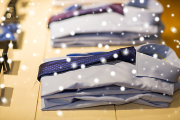 Image showing close up of shirts with ties at clothing store