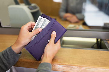 Image showing hands with money at bank or currency exchanger