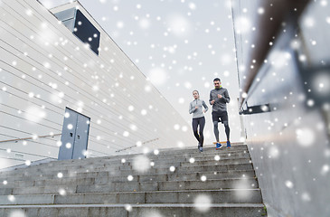 Image showing couple of sportsmen running downstairs outdoors