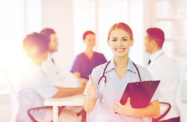 Image showing happy doctor over group of medics at hospital