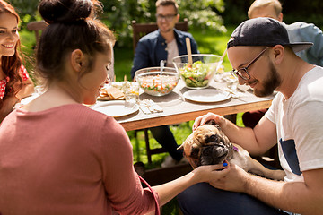 Image showing happy friends having dinner at summer garden party