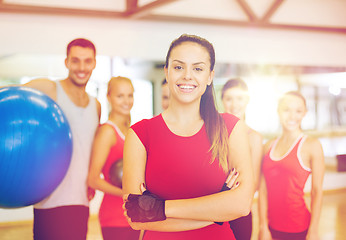 Image showing woman standing in front of the group in gym