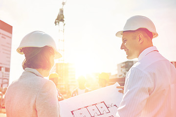 Image showing happy architects with blueprint at building