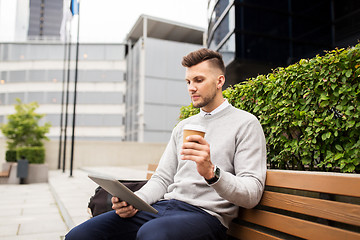 Image showing man with tablet pc and coffee on city street bench