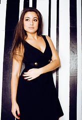 Image showing young pretty cool fat brunette woman with long hair fashion dressed in little black dress happy smiling, lifestyle people concept