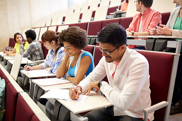 Image showing group of students with notebooks in lecture hall