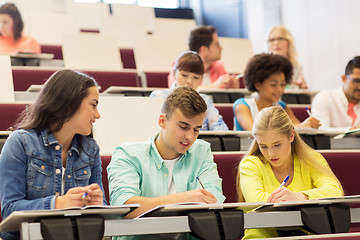 Image showing group of students with notebooks in lecture hall