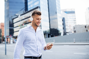 Image showing man with headphones and smartphone listening music