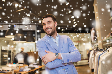 Image showing happy young man in jacket at clothing store