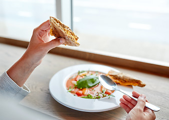 Image showing woman eating gazpacho soup at restaurant