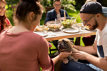 Image showing happy friends having dinner at summer garden party