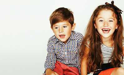 Image showing little cute boy and girl hugging playing on white background, ha