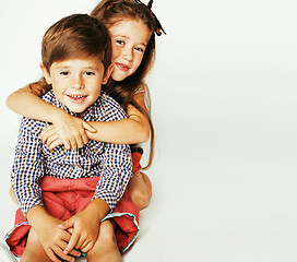 Image showing little cute boy and girl hugging playing on white background, ha