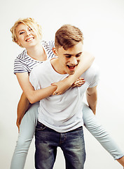 Image showing young pretty teenage couple, hipster guy with his girlfriend happy smiling and hugging isolated on white background, lifestyle people concept