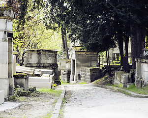 Image showing Tombstones in cemetery at dusk, gothic style crosses summer