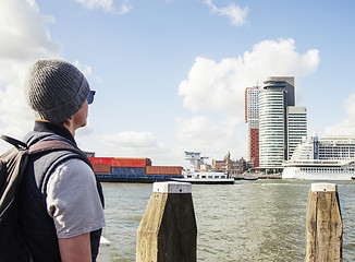 Image showing Young modern guy in hat and sunglasses, tourist with backpack lo