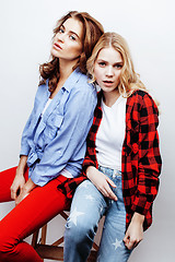 Image showing two pretty blond woman having fun together on white background, mature mother and young teenage daughter, lifestyle people concept