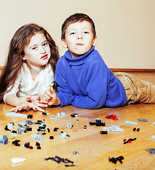 Image showing funny cute children playing lego at home, boys and girl smiling, first education role lifestyle