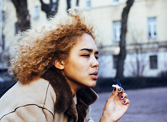 Image showing young pretty girl teenage outside smoking cigarette close up, lo