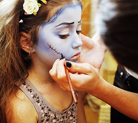 Image showing little cute child making facepaint on birthday party, zombie Apo