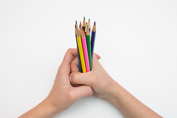 Image showing Female hand clenched in a fist dozen pencils