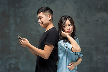 Image showing Asian young couple using cellphone, closeup portrait.