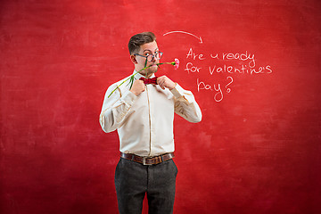 Image showing Man holding bouquet on red