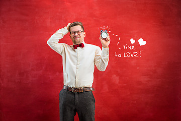 Image showing Young funny man with abstract clock