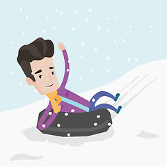 Image showing Man sledding on snow rubber tube in the mountains.