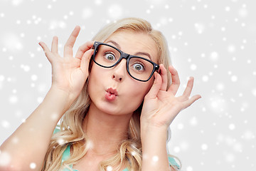 Image showing happy young woman in glasses making fish face