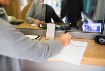 Image showing customer writing application at bank office