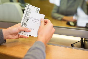 Image showing customer with money and receipt at bank counter