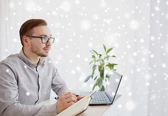 Image showing creative man or businessman writing to notebook