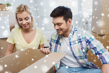 Image showing smiling couple with big boxes moving to new home