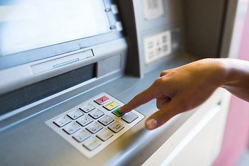 Image showing close up of hand entering pin code at atm machine