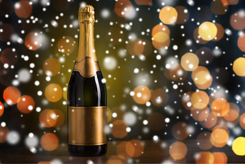 Image showing bottle of champagne with golden label over snow