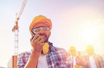 Image showing builder in hardhat with walkie talkie