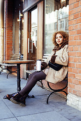 Image showing young pretty african american women drinking coffee outside in c