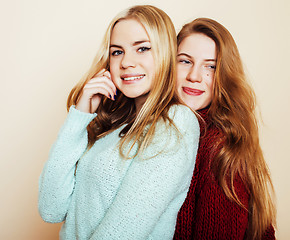 Image showing Two young girlfriends in winter sweaters indoors having fun. Lif