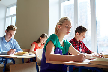 Image showing group of students with books writing school test