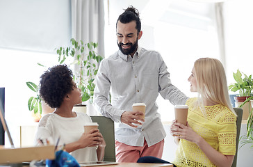 Image showing happy creative team drinking coffee in office