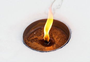 Image showing christmas outdoor candle burning on snow in winter