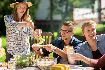 Image showing happy friends having dinner at summer garden party