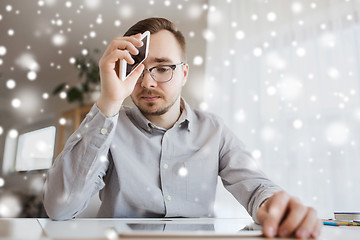 Image showing businessman with smartphone at home office